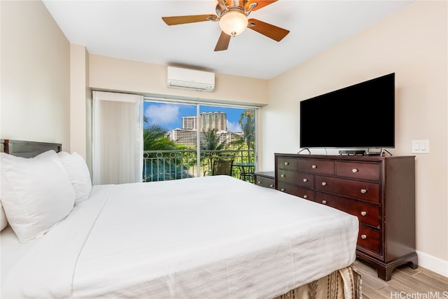 bedroom with light hardwood / wood-style flooring, access to outside, an AC wall unit, and ceiling fan