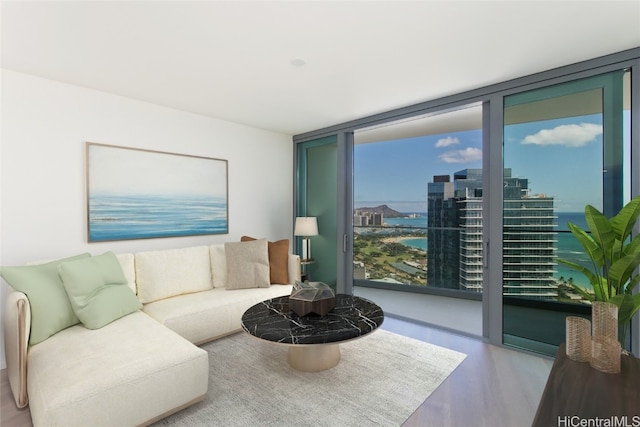 living room featuring a water view, light hardwood / wood-style flooring, and floor to ceiling windows