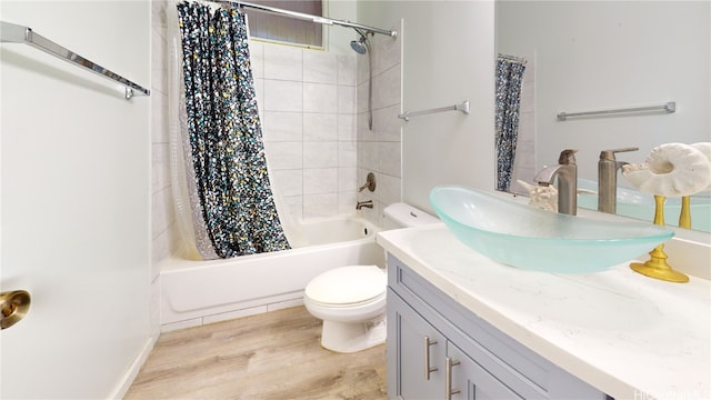 full bathroom featuring vanity, hardwood / wood-style floors, shower / bath combination with curtain, and toilet