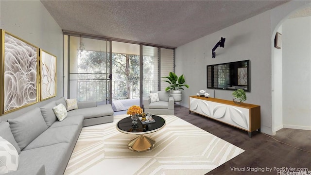 living room featuring expansive windows, dark hardwood / wood-style flooring, and a textured ceiling