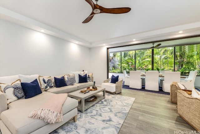 living room featuring light hardwood / wood-style floors and ceiling fan