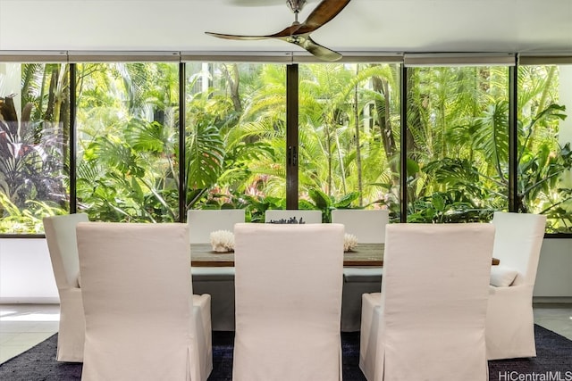 unfurnished sunroom with ceiling fan