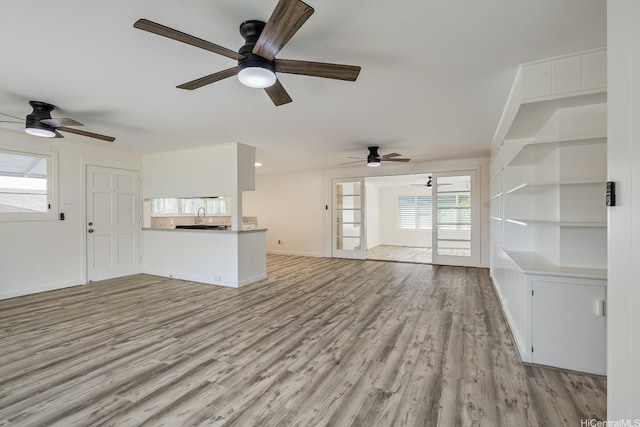 2340 University Ave, Honolulu, HI 96822 - unfurnished living room with wood finished floors, baseboards, and ceiling fan