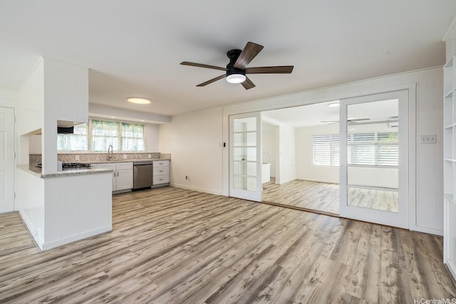 2340 University Ave, Honolulu, HI 96822 - kitchen with stainless steel dishwasher, a ceiling fan, light wood-style floors, light countertops, and white cabinetry