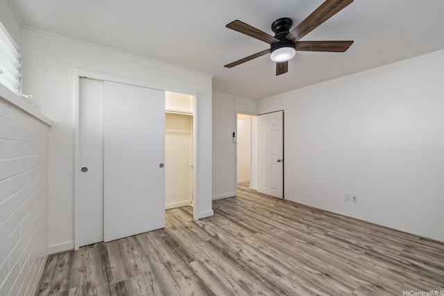 2340 University Ave, Honolulu, HI 96822 - unfurnished bedroom with light wood-style flooring, a closet, and a ceiling fan