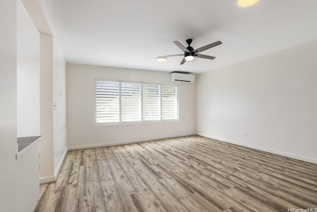 2340 University Ave, Honolulu, HI 96822 - unfurnished room featuring baseboards, wood finished floors, ceiling fan, and a wall mounted air conditioner