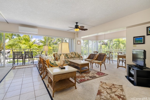 living room featuring ceiling fan, an AC wall unit, a textured ceiling, and light tile patterned floors