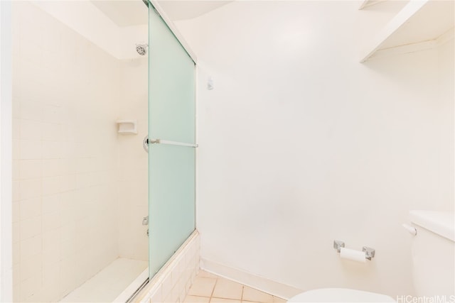 bathroom with toilet and tile patterned flooring