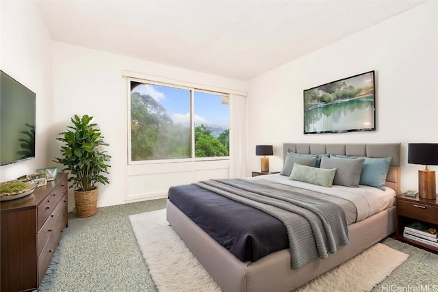 bedroom featuring light colored carpet