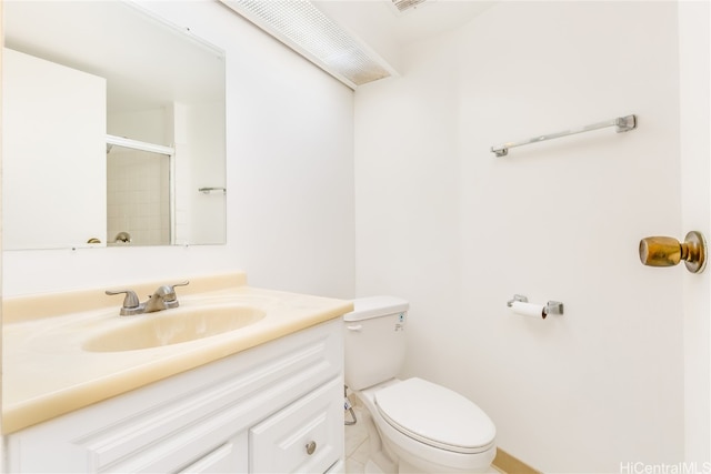 bathroom featuring vanity, toilet, and an enclosed shower