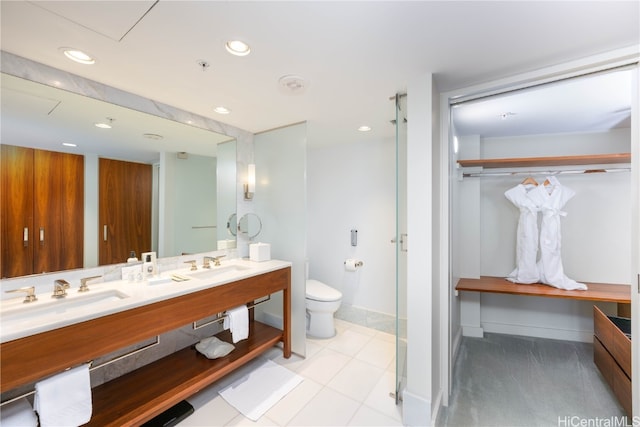 bathroom with vanity, toilet, and tile patterned flooring