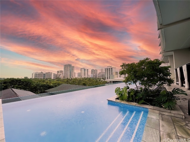 view of pool at dusk