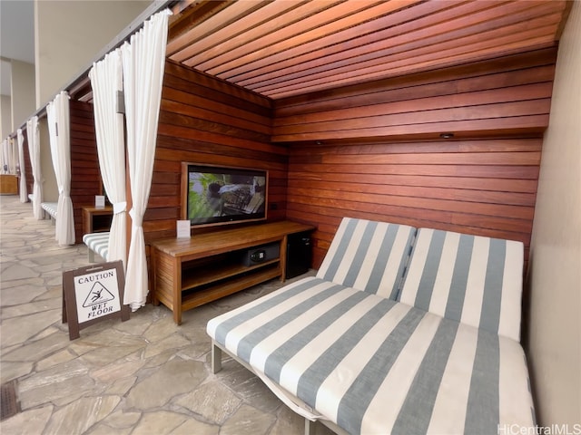 unfurnished bedroom featuring wood ceiling and wooden walls