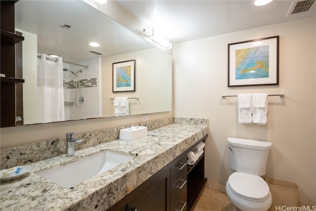 bathroom featuring vanity, tile patterned floors, toilet, and walk in shower