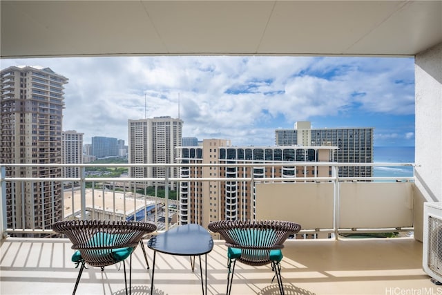 balcony with a water view and a beach view