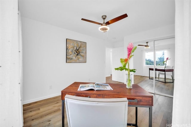 home office featuring hardwood / wood-style flooring and ceiling fan