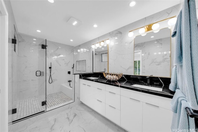 bathroom featuring vanity and a shower with shower door