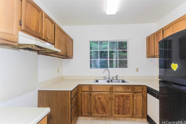 kitchen featuring dishwasher, sink, light tile patterned floors, black double oven, and range hood