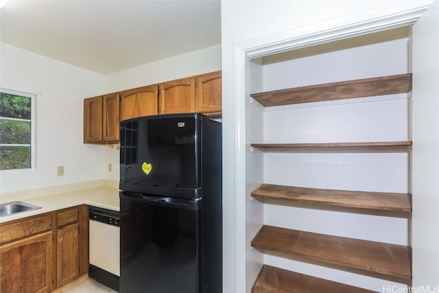 kitchen featuring black refrigerator and dishwasher