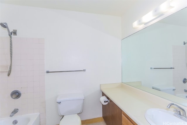 full bathroom with vanity, toilet, and tiled shower / bath