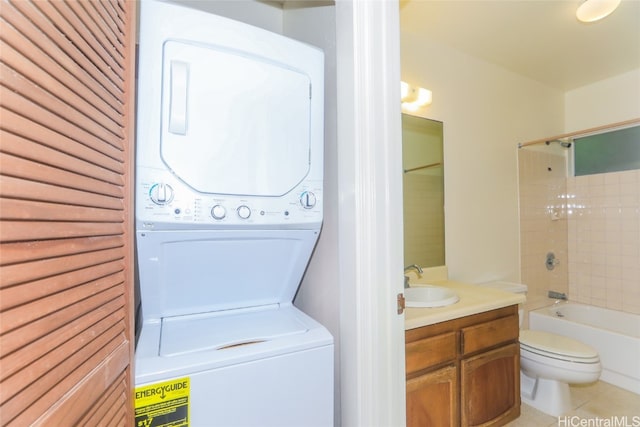 laundry room featuring light tile patterned floors, sink, and stacked washer / dryer