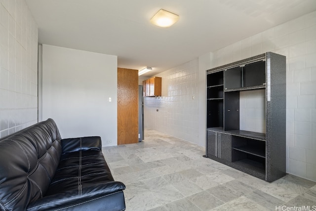 living room with tile walls