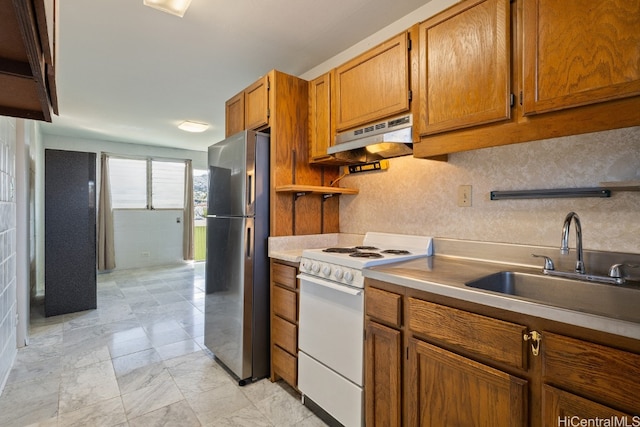 kitchen with sink, stainless steel fridge, white stove, and range hood