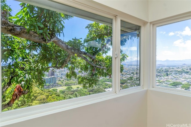 unfurnished sunroom featuring a mountain view