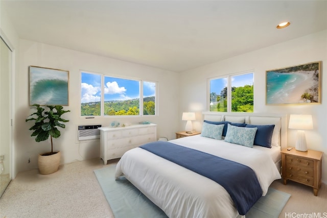 carpeted bedroom featuring a wall unit AC and multiple windows