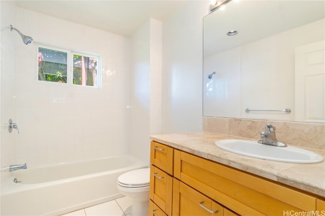 full bathroom featuring tile patterned flooring, vanity, toilet, and tiled shower / bath