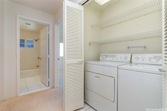 washroom featuring washing machine and dryer and light carpet