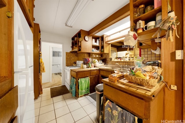 kitchen with decorative backsplash, light tile patterned flooring, and white appliances