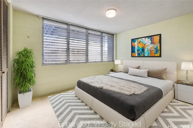 carpeted bedroom with a textured ceiling