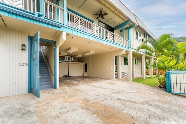 exterior space featuring a balcony and ceiling fan