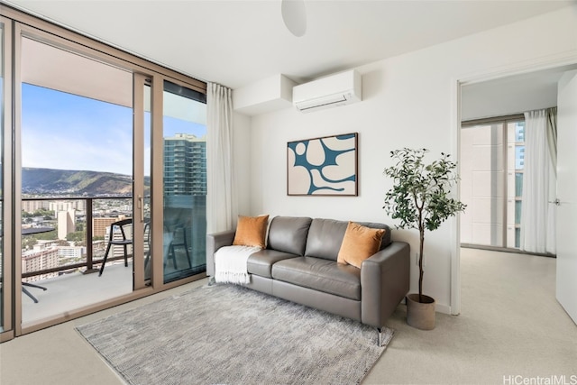 carpeted living room with a wealth of natural light, a mountain view, and a wall mounted air conditioner