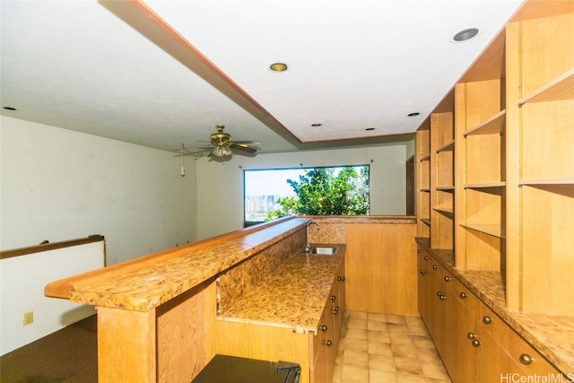 kitchen with a center island, sink, and ceiling fan