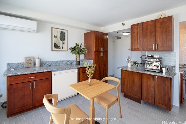 kitchen with backsplash, light hardwood / wood-style floors, a wall unit AC, light stone counters, and white refrigerator