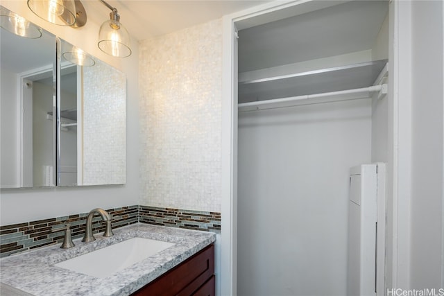 bathroom featuring vanity and decorative backsplash