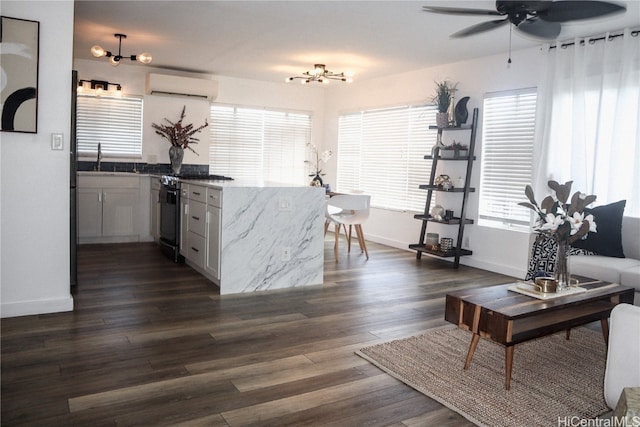 interior space featuring ceiling fan, a wall mounted air conditioner, and dark hardwood / wood-style flooring