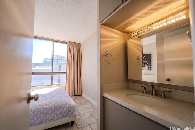 bathroom featuring vanity, tile patterned floors, floor to ceiling windows, and a textured ceiling