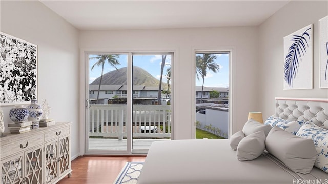 bedroom featuring hardwood / wood-style flooring and access to outside