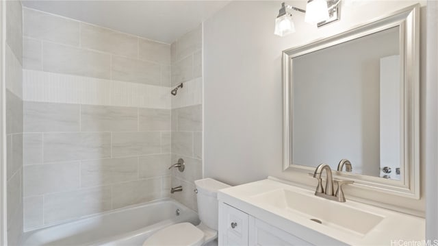 full bathroom with tiled shower / bath, vanity, and toilet