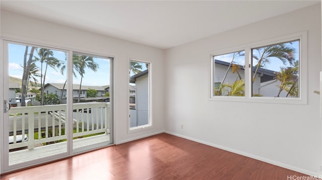 doorway to outside featuring hardwood / wood-style flooring and a healthy amount of sunlight