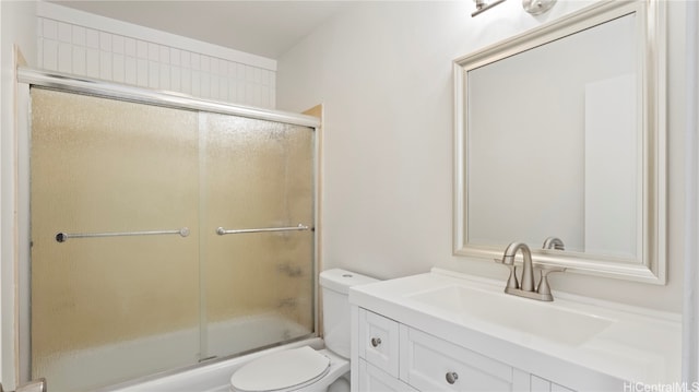 full bathroom with vanity, enclosed tub / shower combo, and toilet