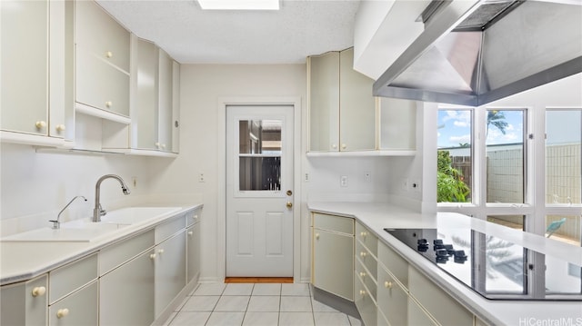 kitchen with gray cabinets, exhaust hood, black electric stovetop, light tile patterned floors, and a textured ceiling