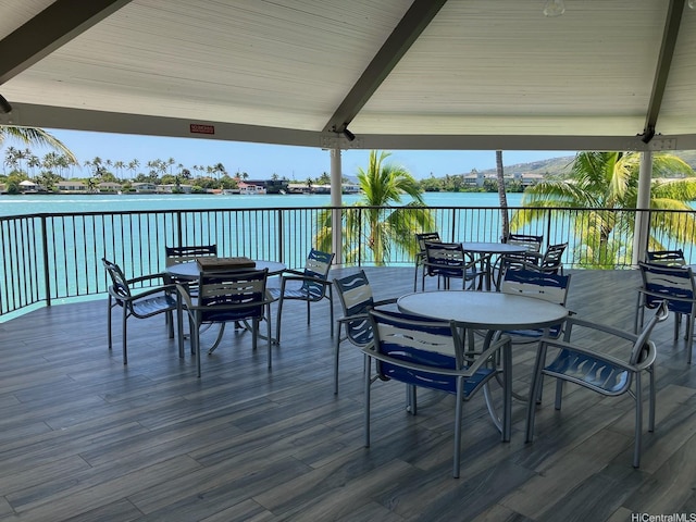 deck featuring a water view and outdoor dining area