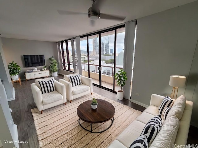 living room with ceiling fan, floor to ceiling windows, and hardwood / wood-style floors