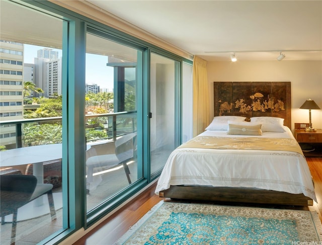 1888 Kalakaua Ave Unit 907, Honolulu, HI 96815 - bedroom featuring a view of city and wood finished floors