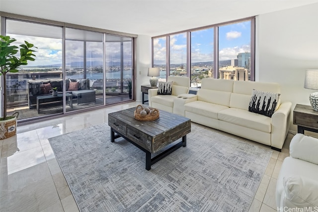 living room with light tile patterned floors and a wall of windows