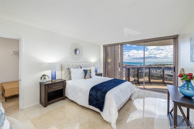 bedroom featuring floor to ceiling windows and access to exterior